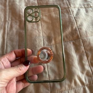 Iphone 11 pro max clear case with green trim. Has a ring phone holder